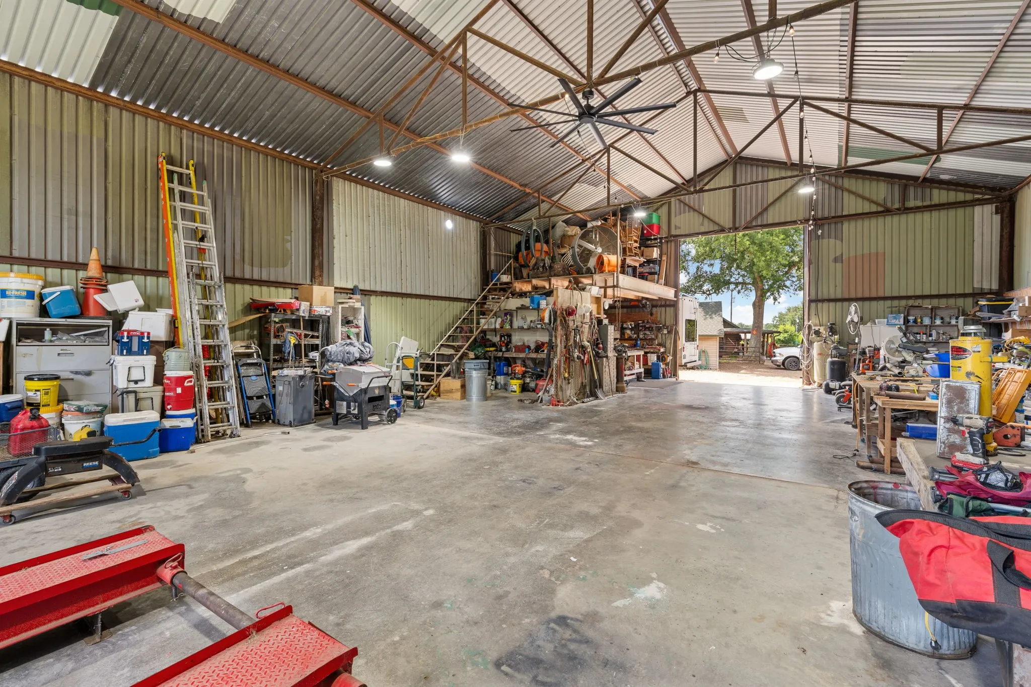 Spacious multi-purpose building with a high-pitched metal roof and industrial lighting