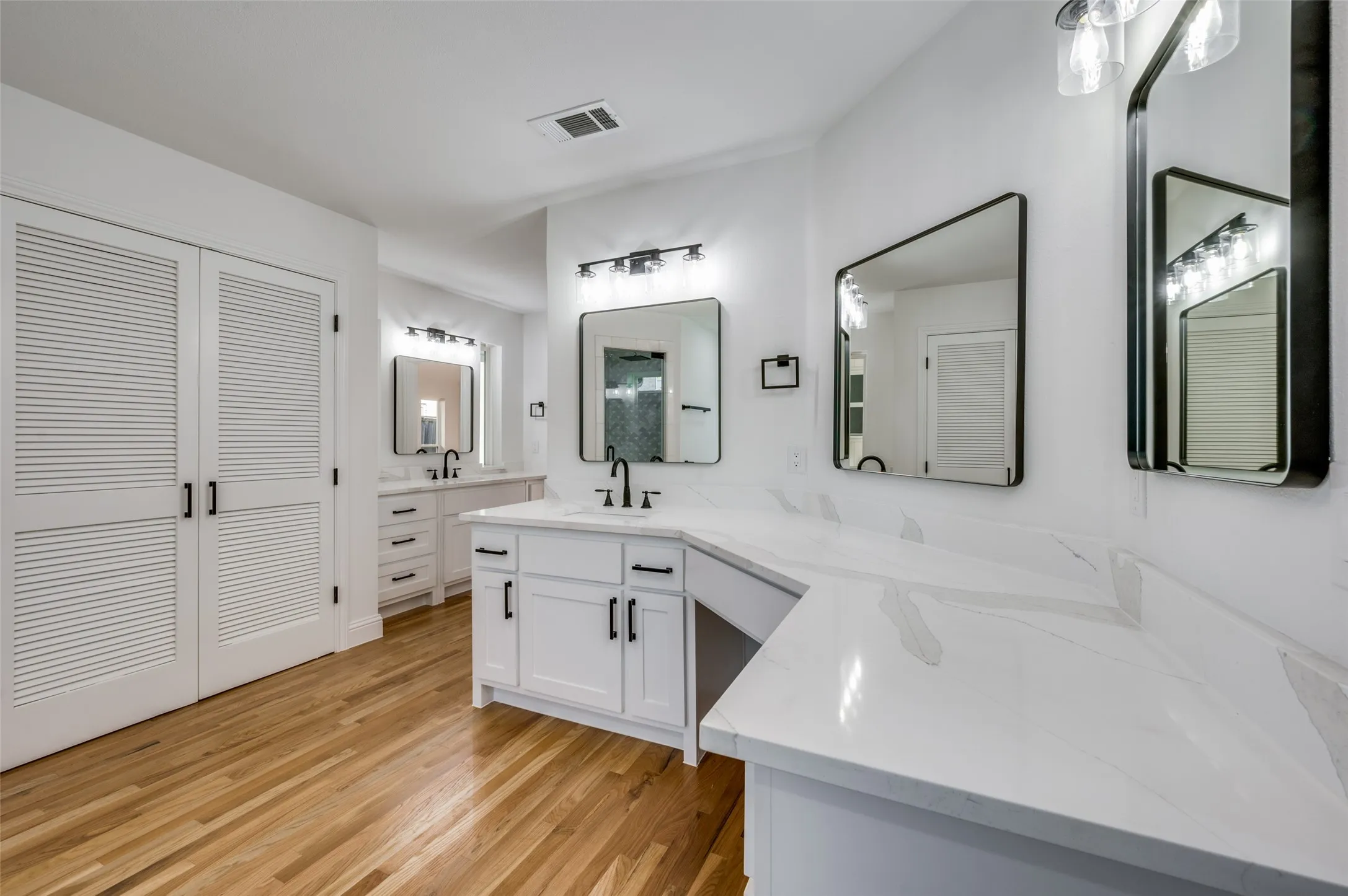 Separate vanities and sinks at primary bath area