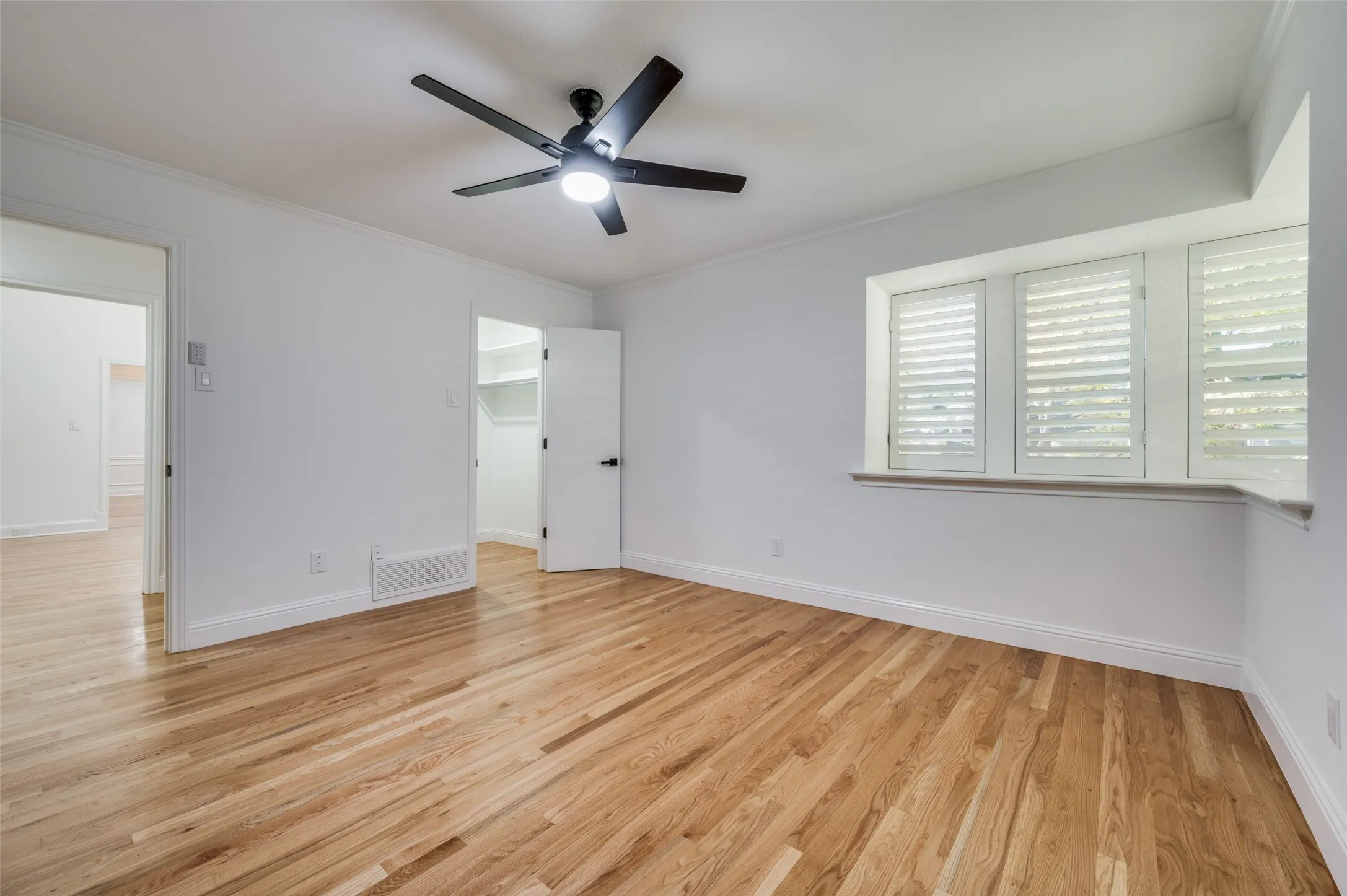 Secondary bedroom at front of home, with study at left rear of photo
