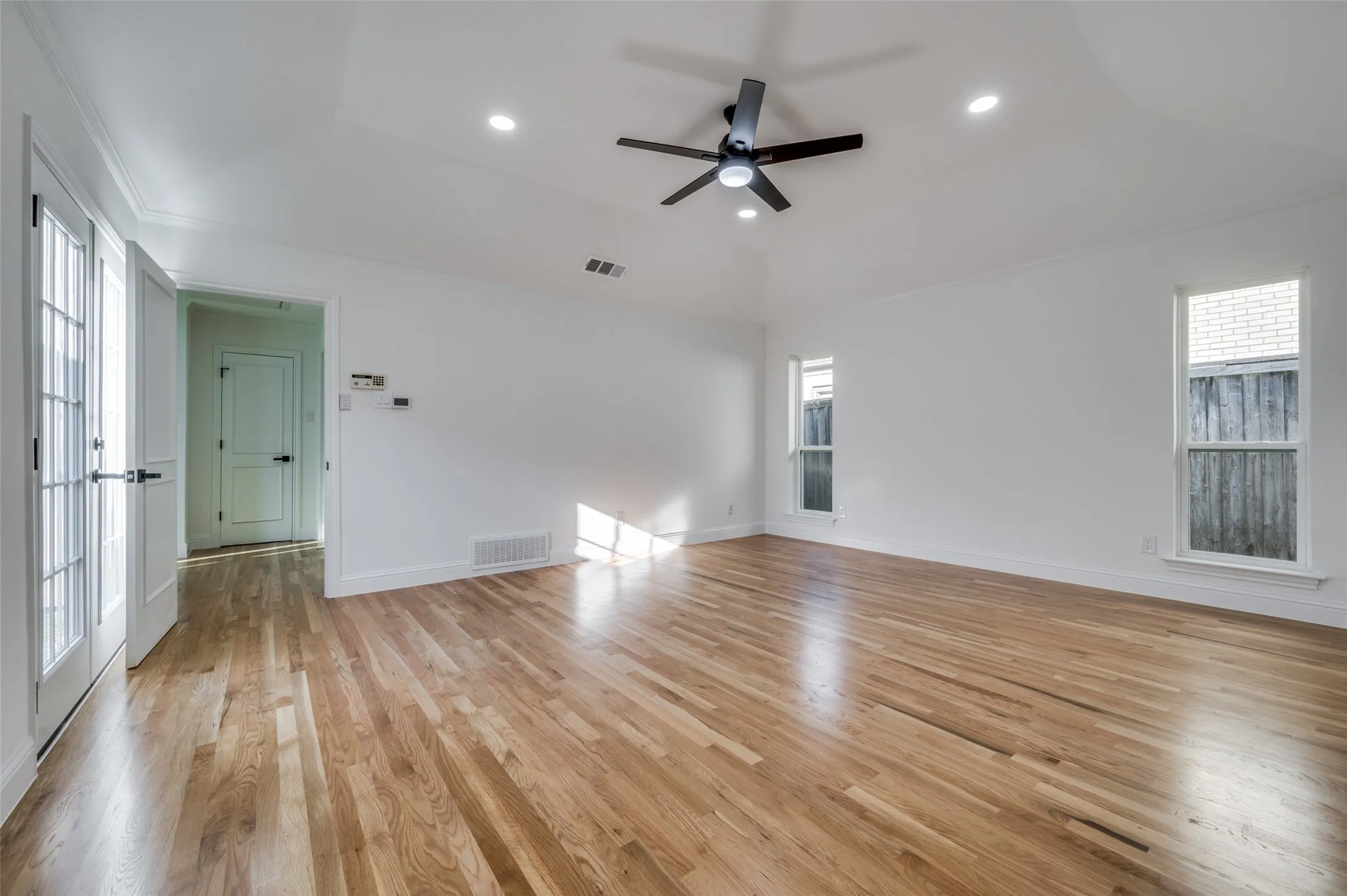 Primary bedroom is split from 2 secondary bedrooms