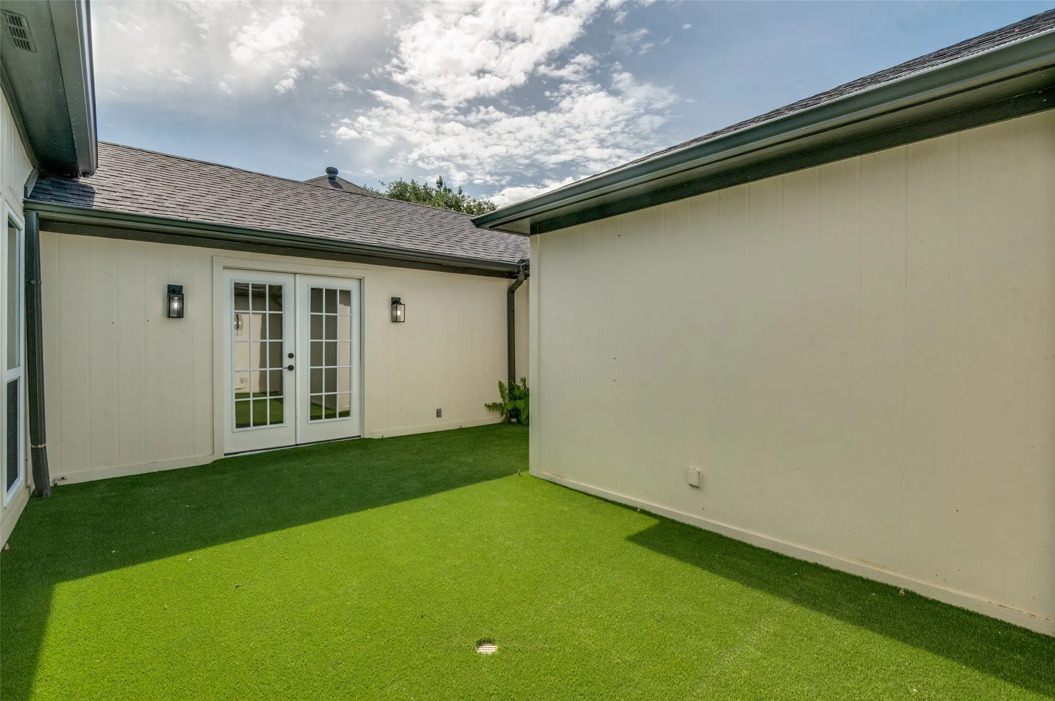 French doors leading to central courtyard from primary bedroom