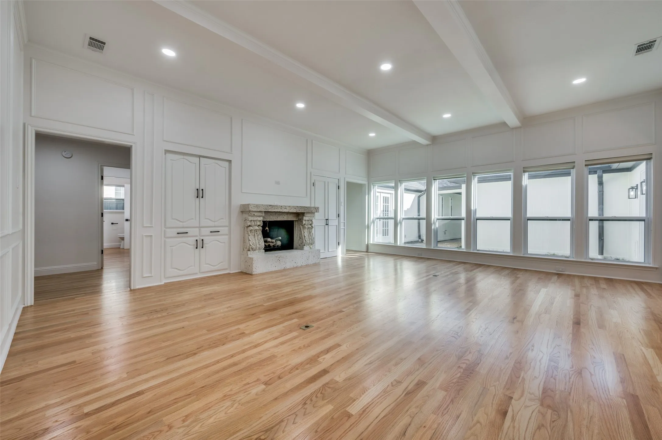 Large family room with fireplace and wet bar (behind double doors to right of FP)