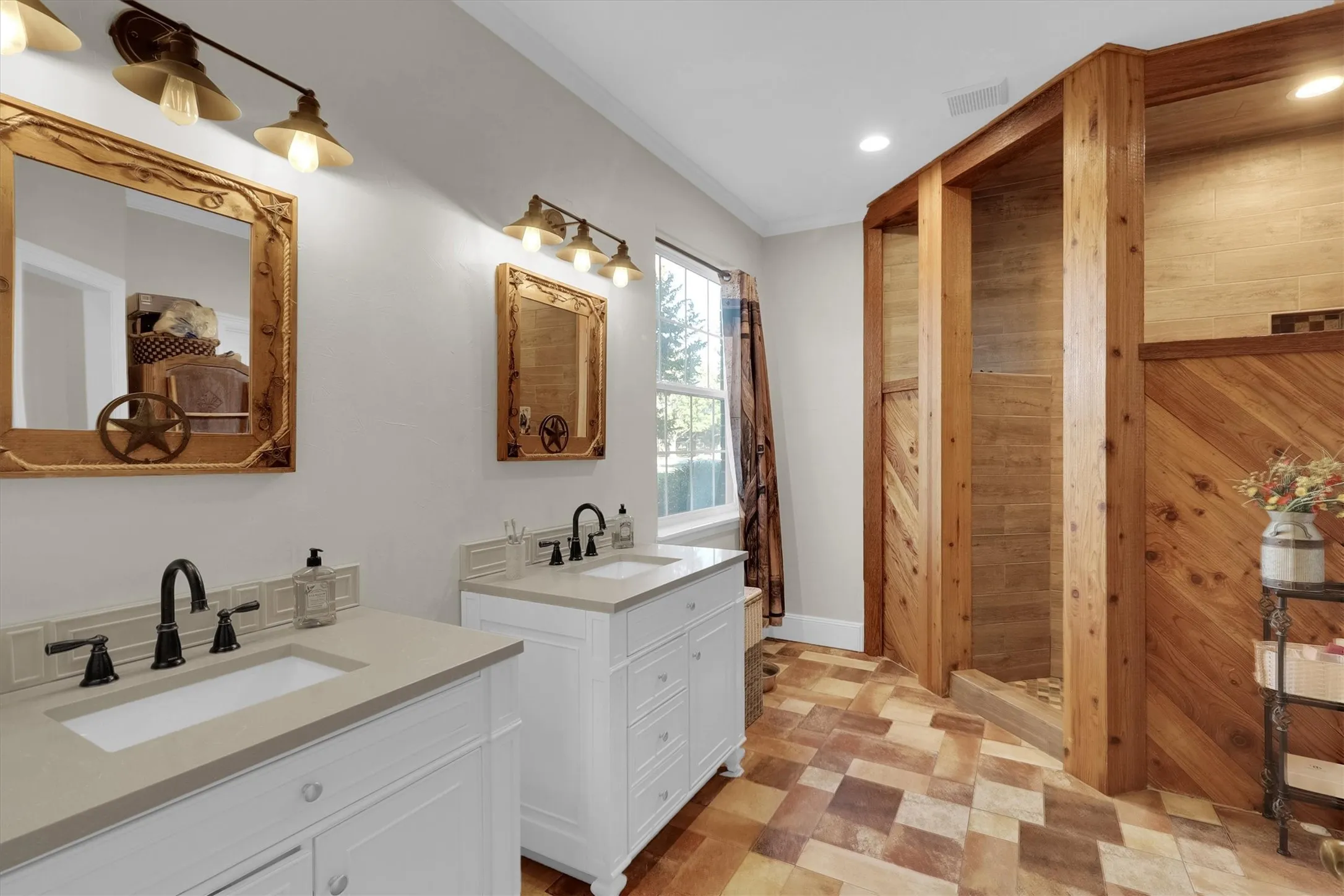 Bathroom with two vanities, ornamental molding, recessed lighting, light floors, and wooden walls