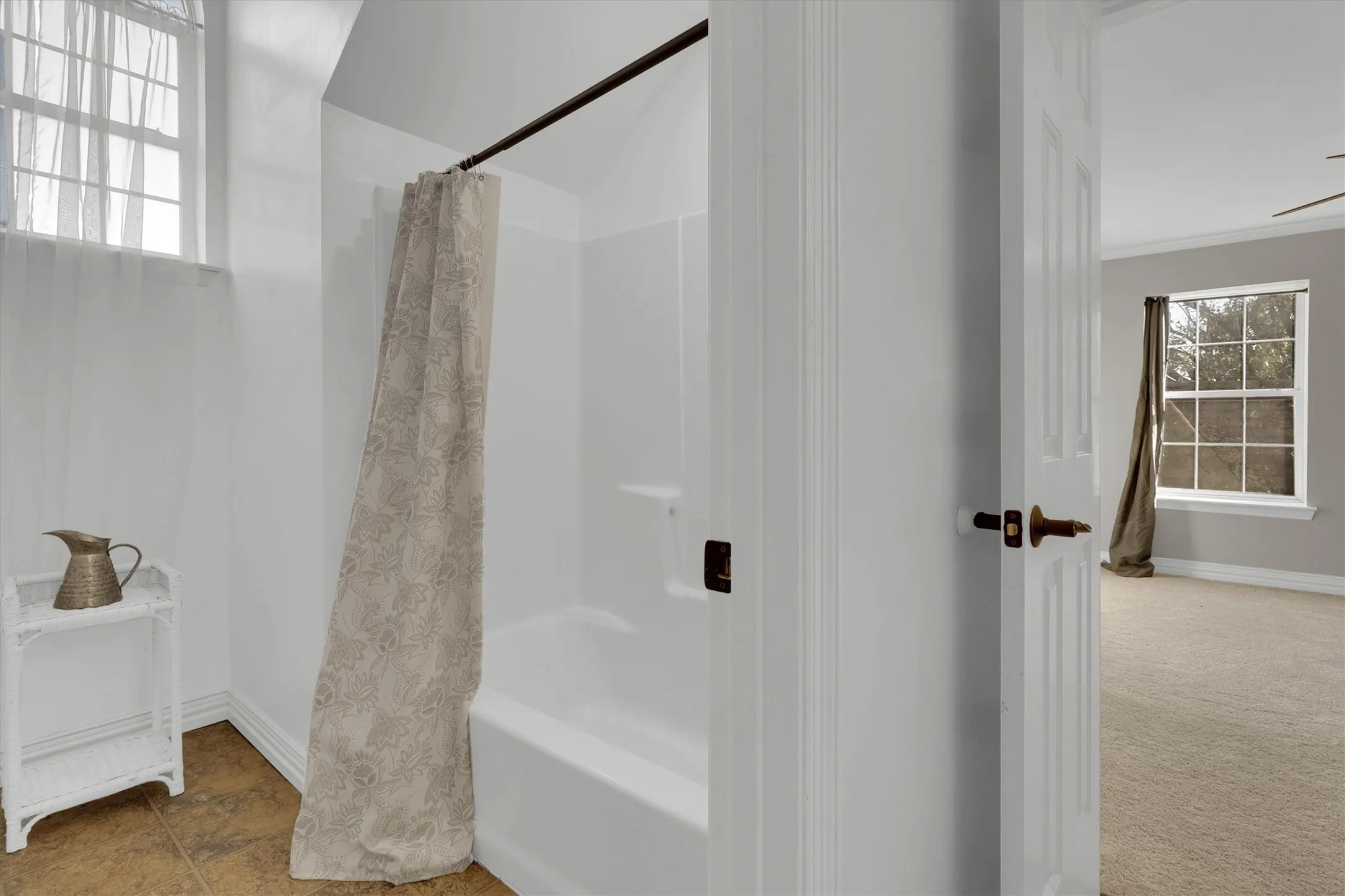 Full bathroom featuring baseboards and shower / tub combo
