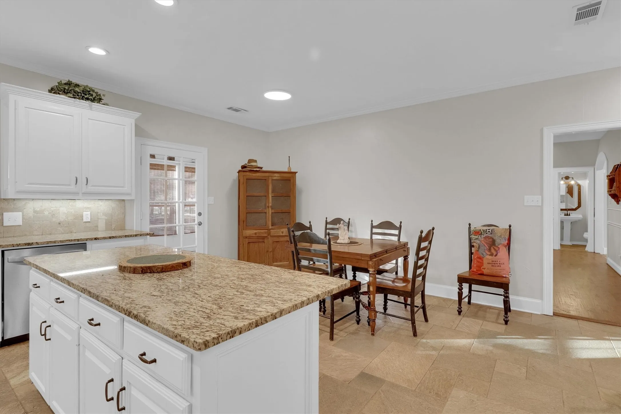 Kitchen featuring white cabinets, dishwasher, backsplash, ornamental molding, and recessed lighting
