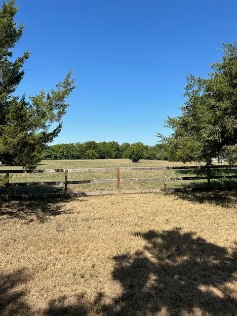 View of yard with a rural view