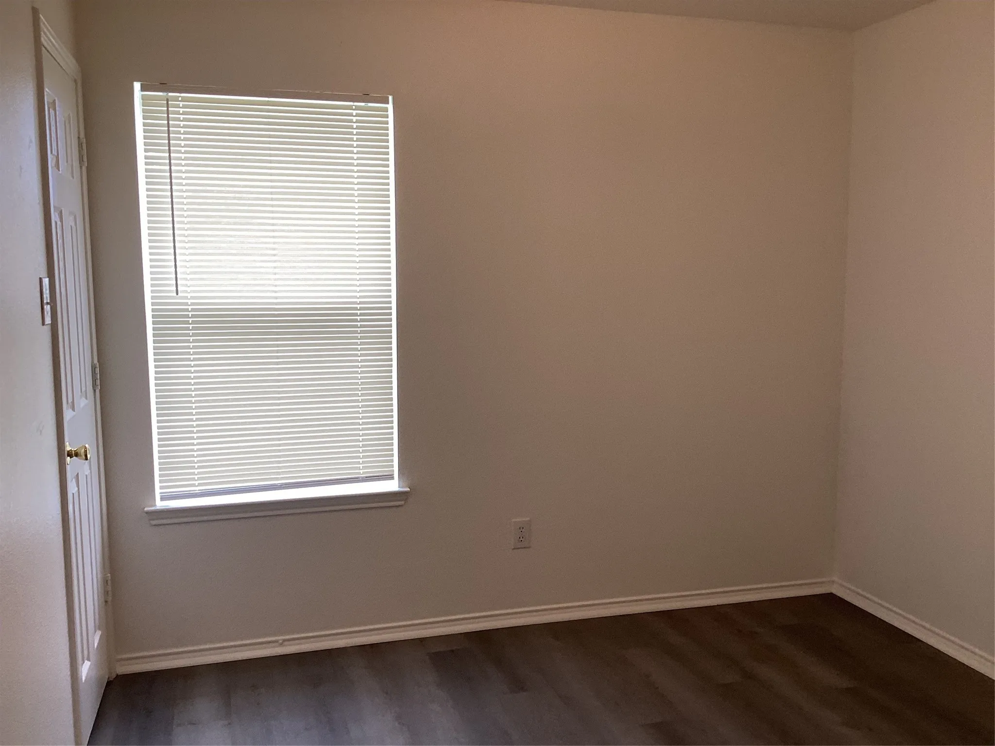 Neutral tone walls with white trim and wood-finish flooring