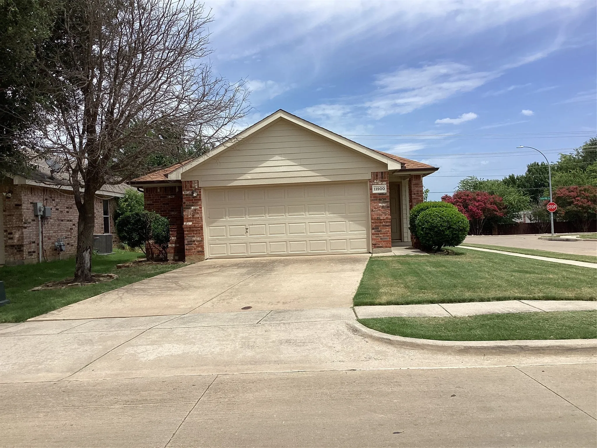 Traditional brick and siding exterior with an attached two-car garage