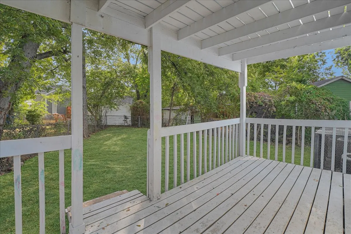 Covered patio with painted wood decking and railings