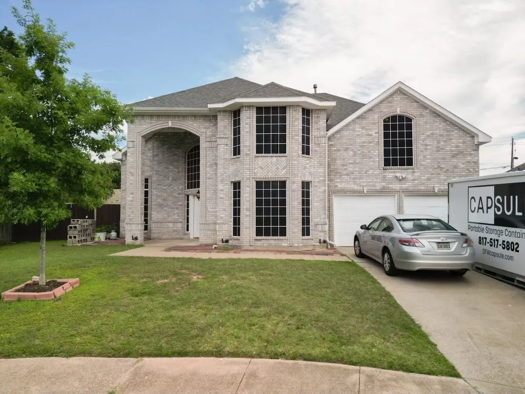 Stately brick exterior featuring an arched entryway and gabled roofline