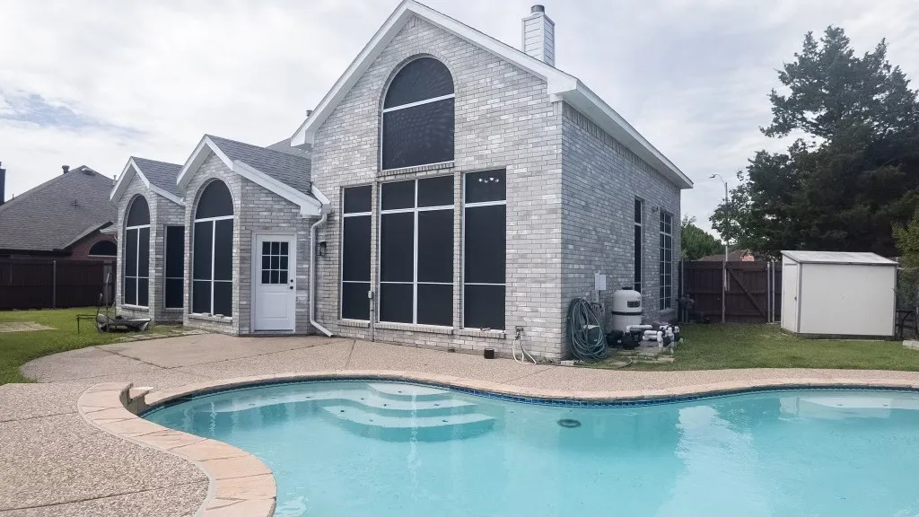 Outdoor swimming pool with integrated steps, surrounded by a concrete patio