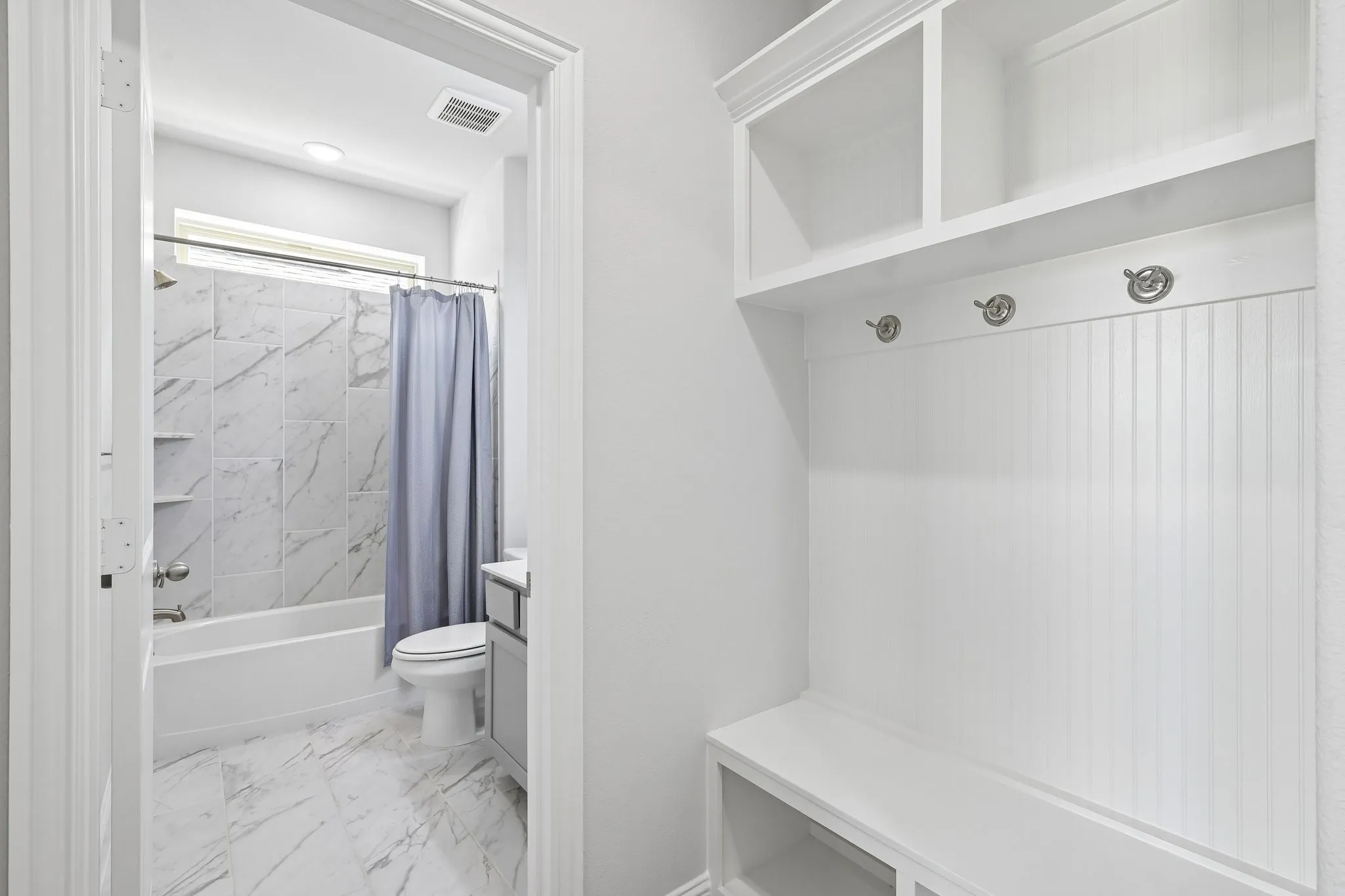 Downstairs full bath and mud bench by garage door