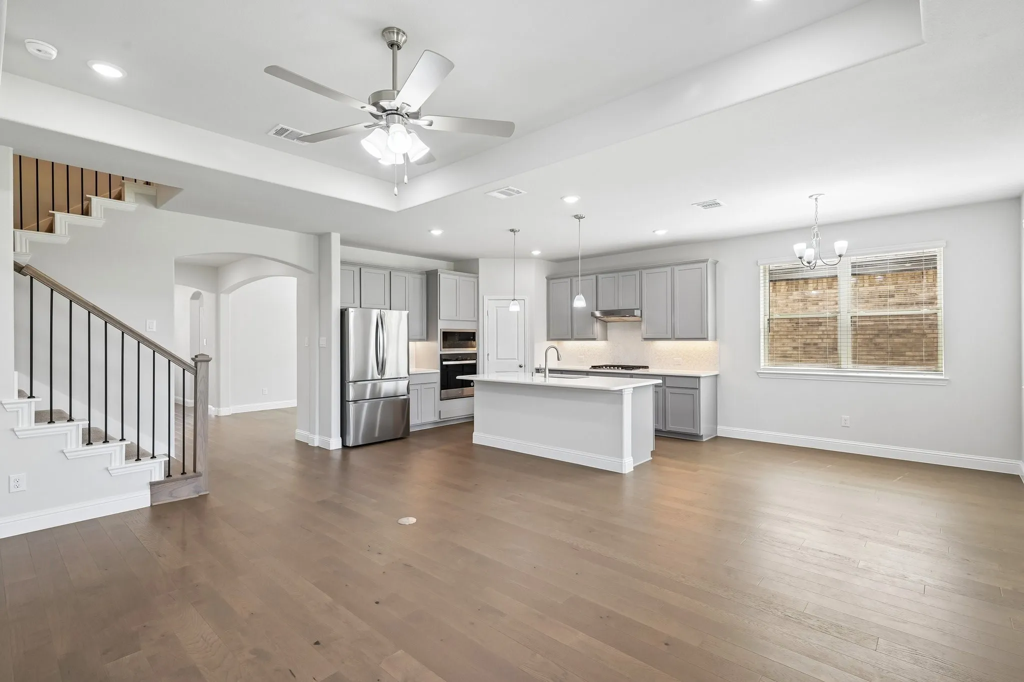 Open concept living space with stairway to upstairs