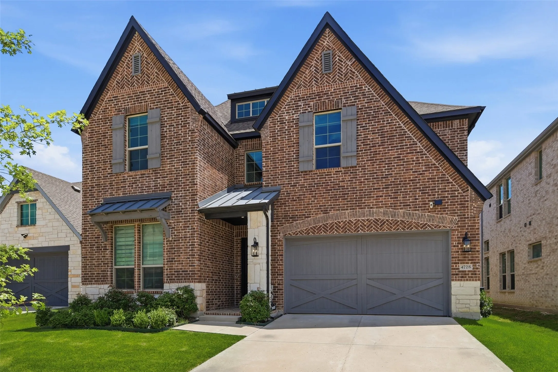 Brick exterior featuring stone accents and dark trim