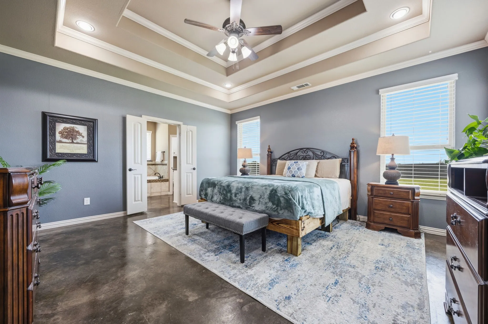 Huge primary bedroom with ensuite bath and coffered ceilings.