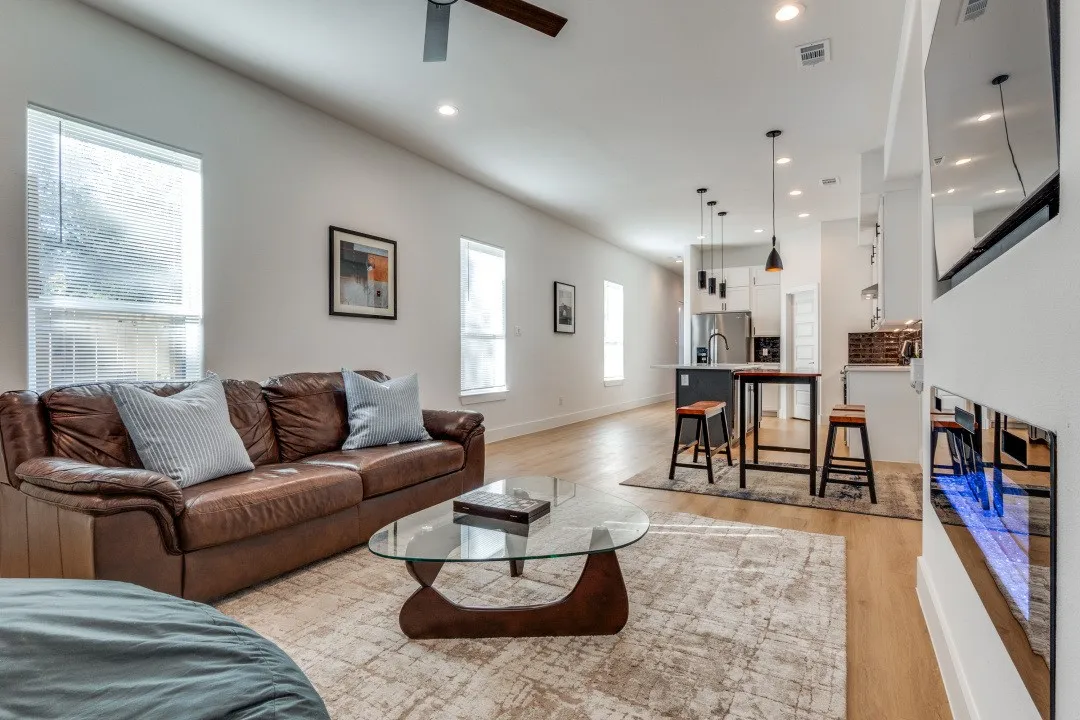 Living room featuring light hardwood / wood-style floors, a wealth of natural light, and ceiling fan