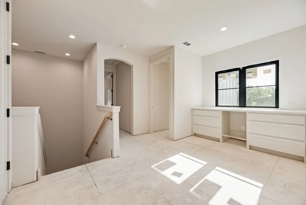 Upstairs flex space with built-in cabinets and beverage cooler.