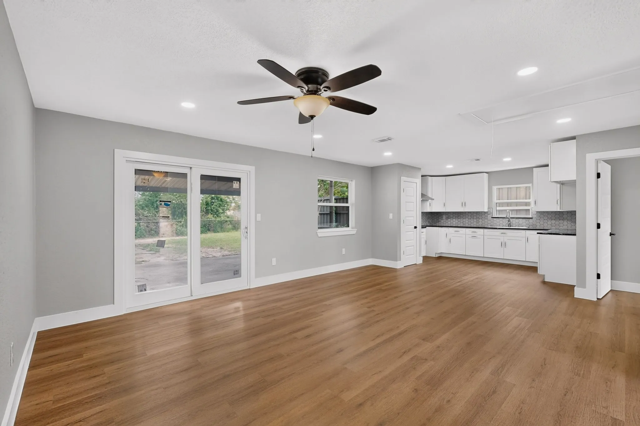Open concept interior featuring wood-finish flooring and light gray walls