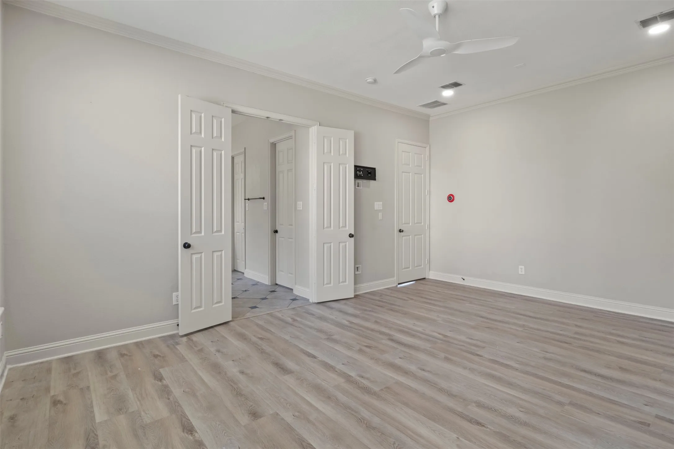 New wood floors.  Double doors lead to the primary bathroom.