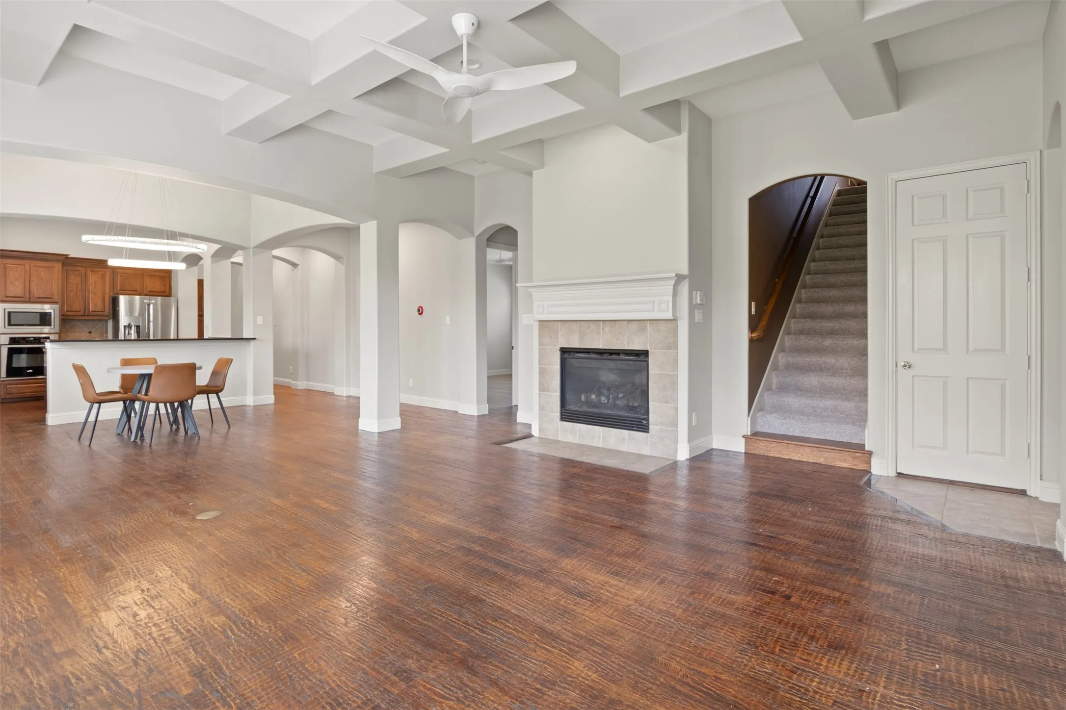 Fireplace, designer ceiling fan and a coffered ceiling.
