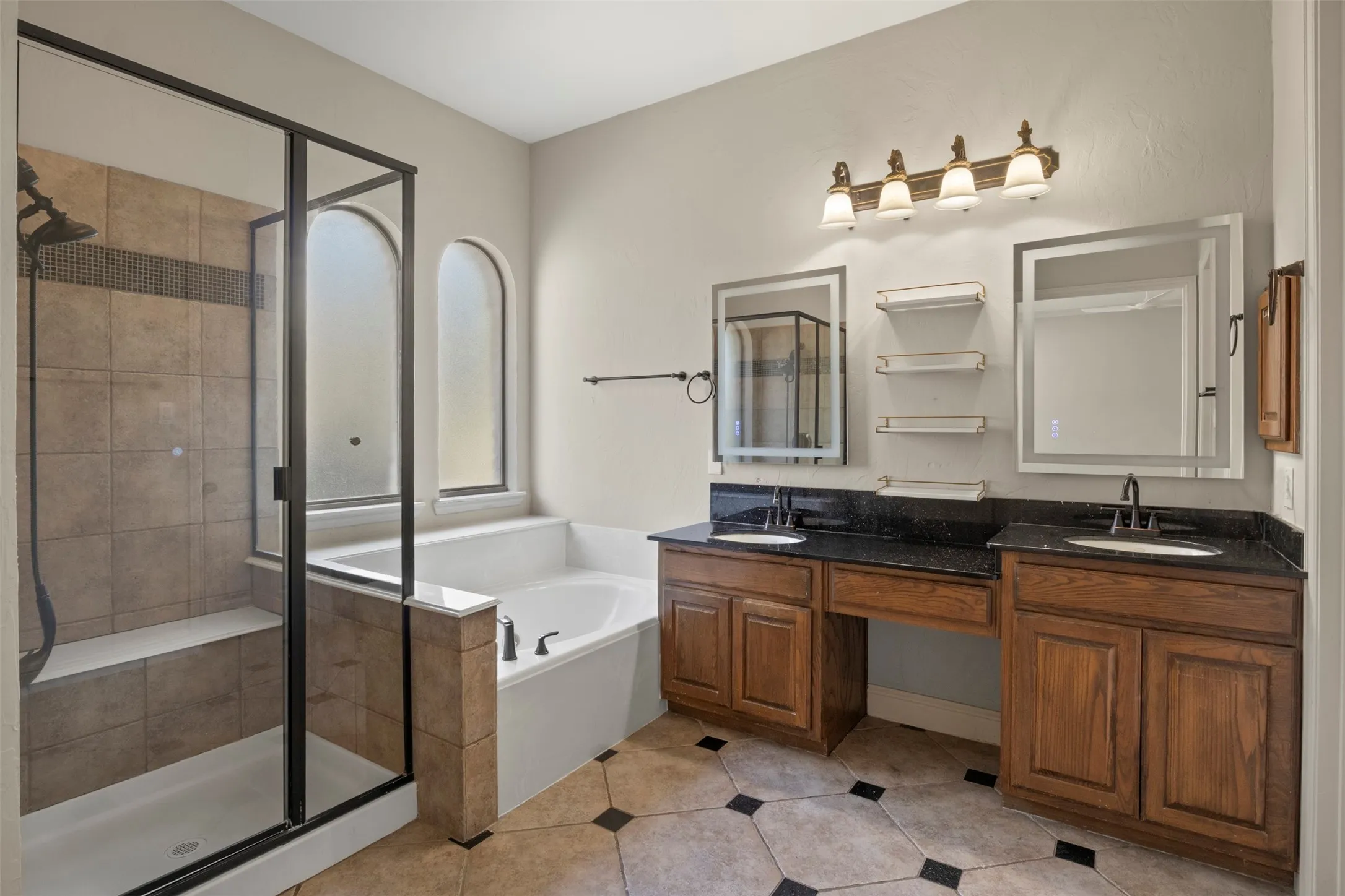 Two charming arched windows allow for plenty of natural light.  Dual sinks with smart mirrors and new faucets. Spacious shower with bench.