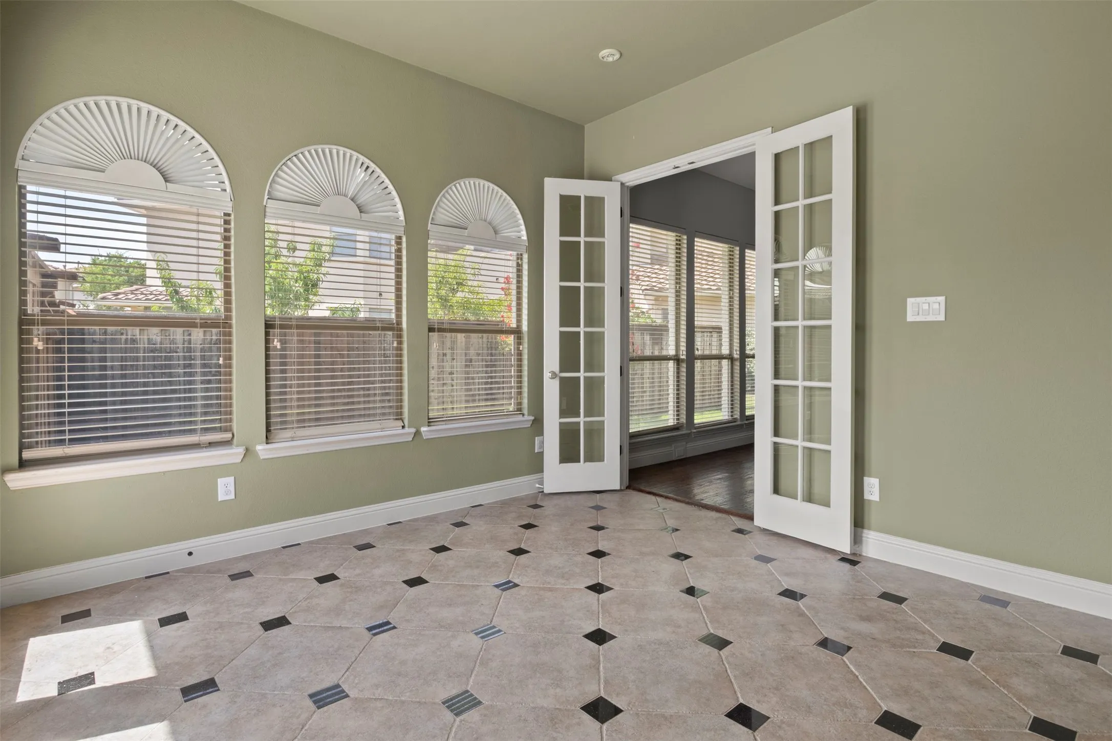 Another view of the sunroom with French doors.