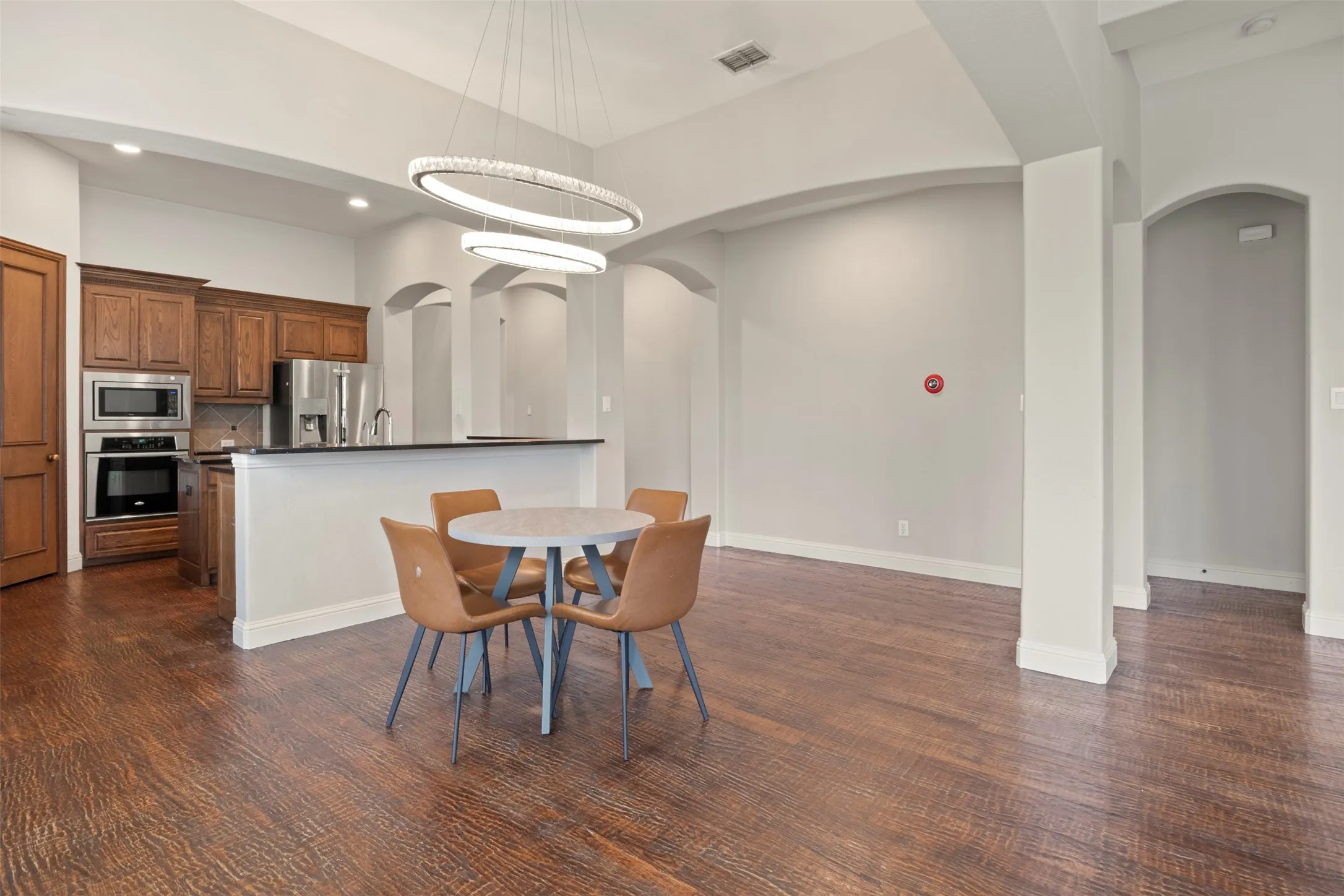 Hand scraped wood floors and a designer light fixture.