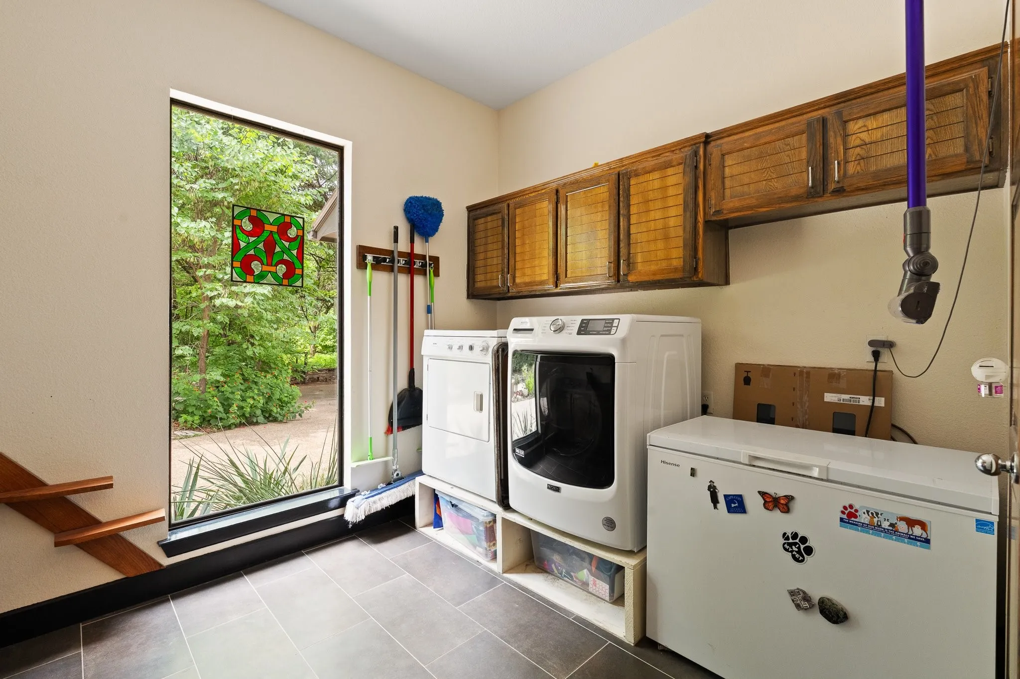 Large laundry room, plenty of natural light and cabinetry