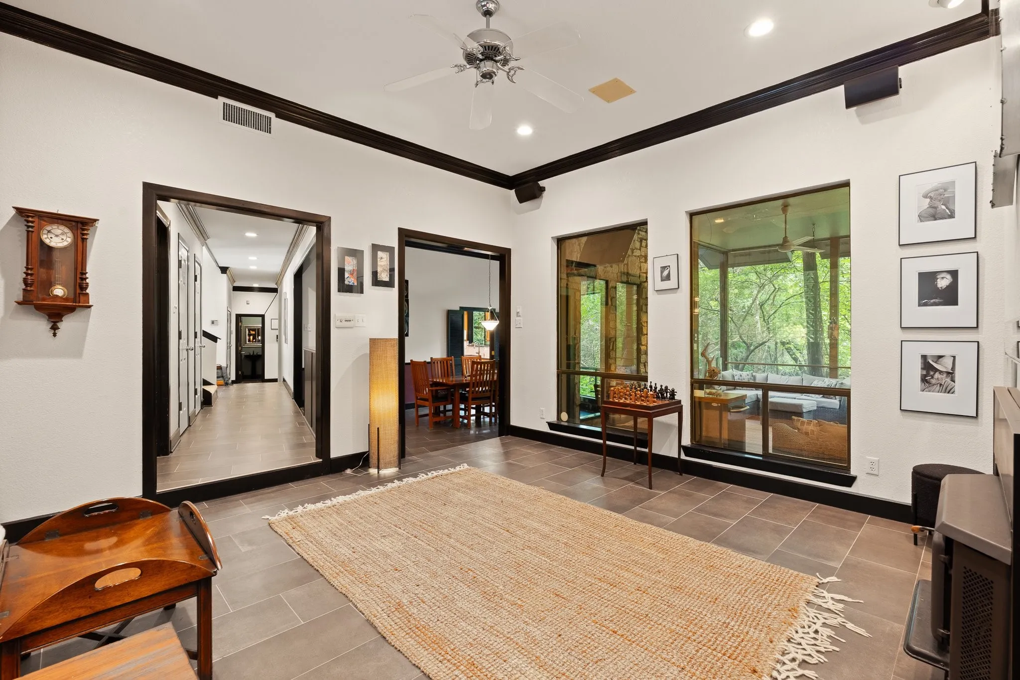 View from downstairs living room looks towards the hallway, dining room and screened in porch through the windows