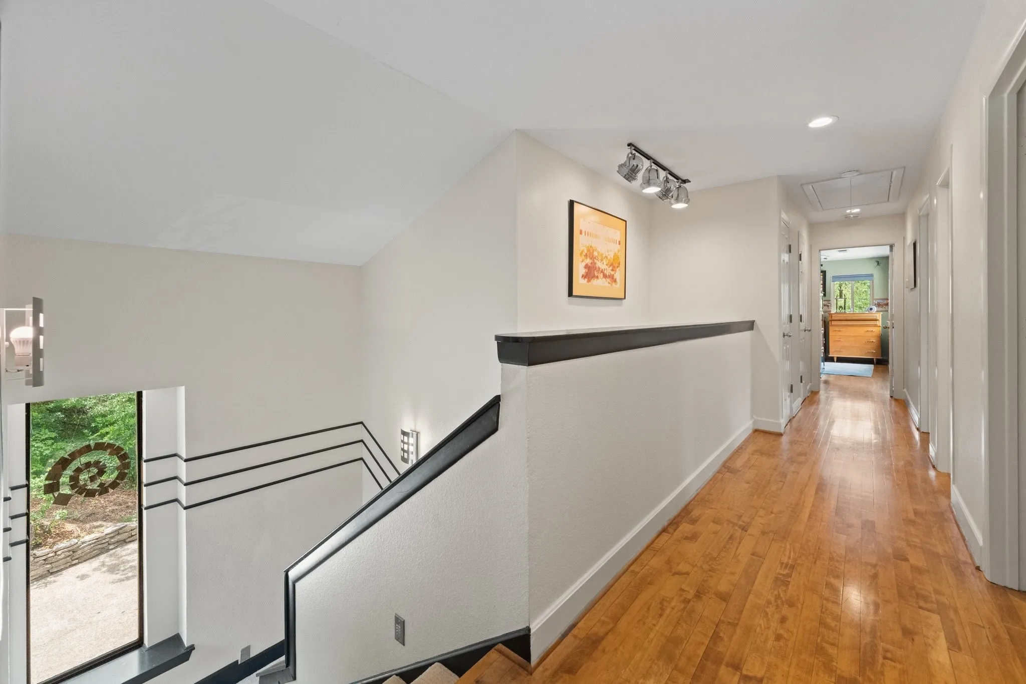 Upstairs hallway with beautiful flooring leading to the office and two bedrooms