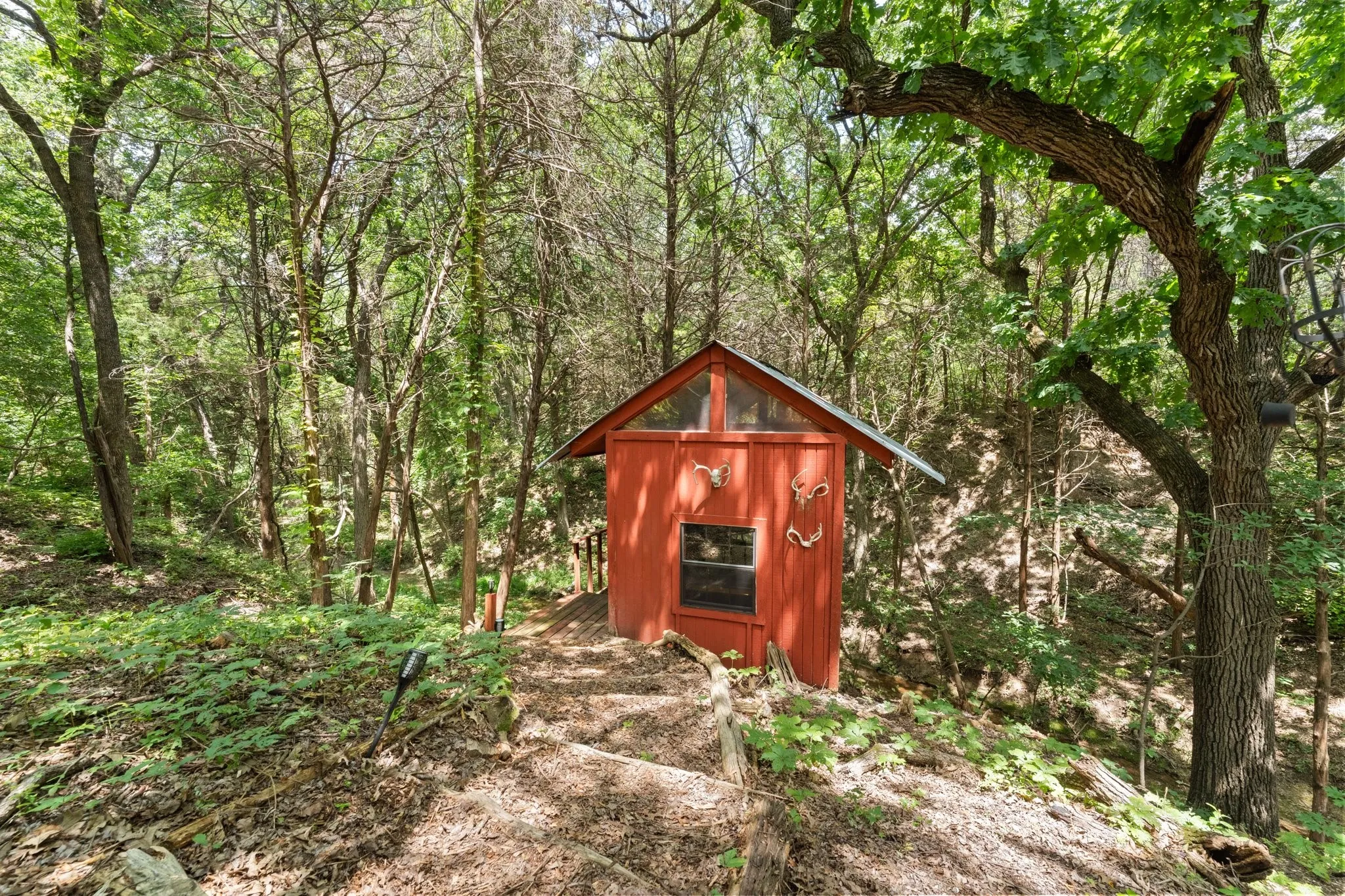 Your view own private clubhouse equipped with electricity and screened in, in the center of it all, mature trees, a running creek, birds chirping, relaxing and private - experience it with a tour, fall in love and become the New Owner