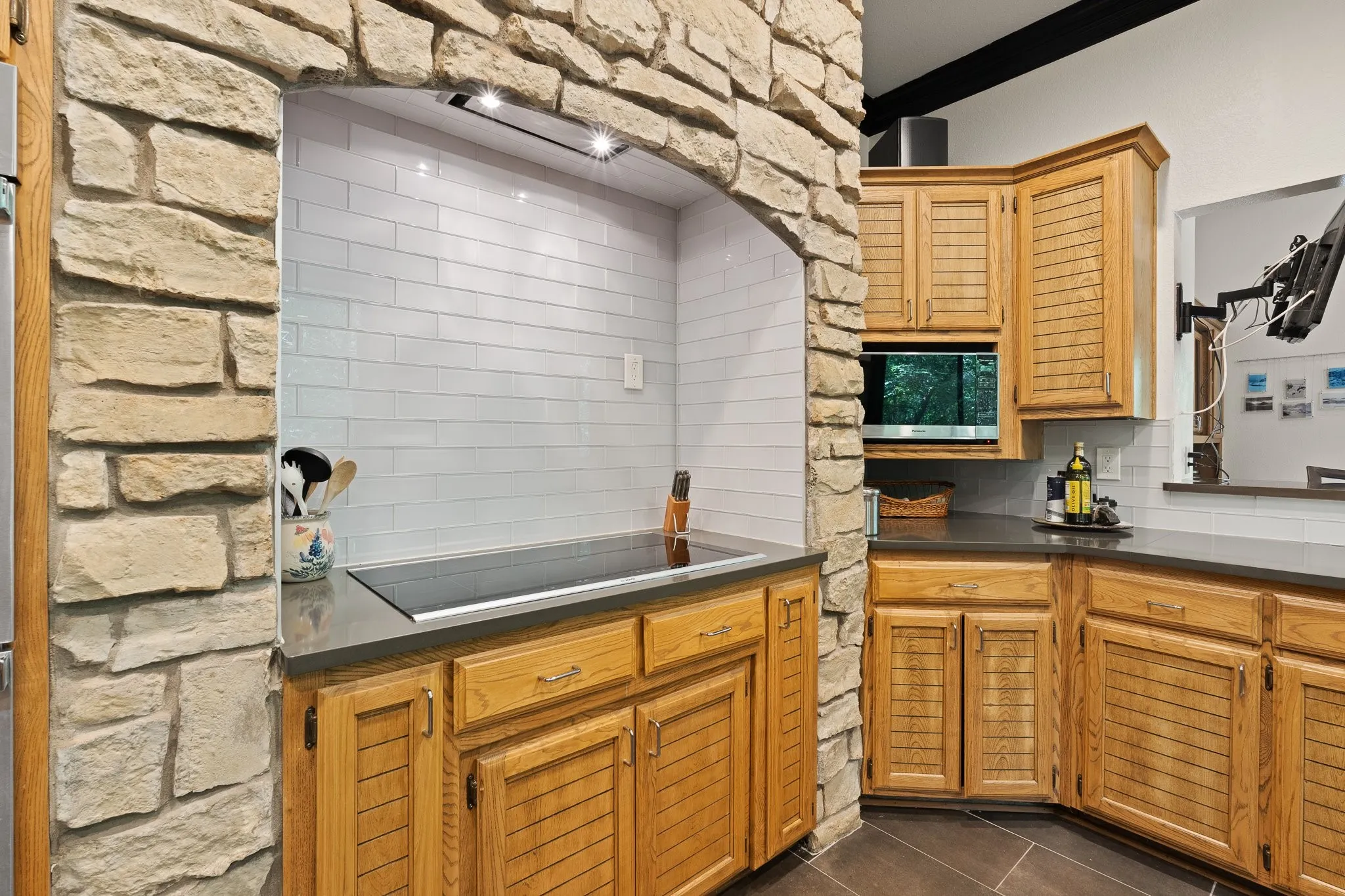 Stone-clad archway framing a built-in cooktop