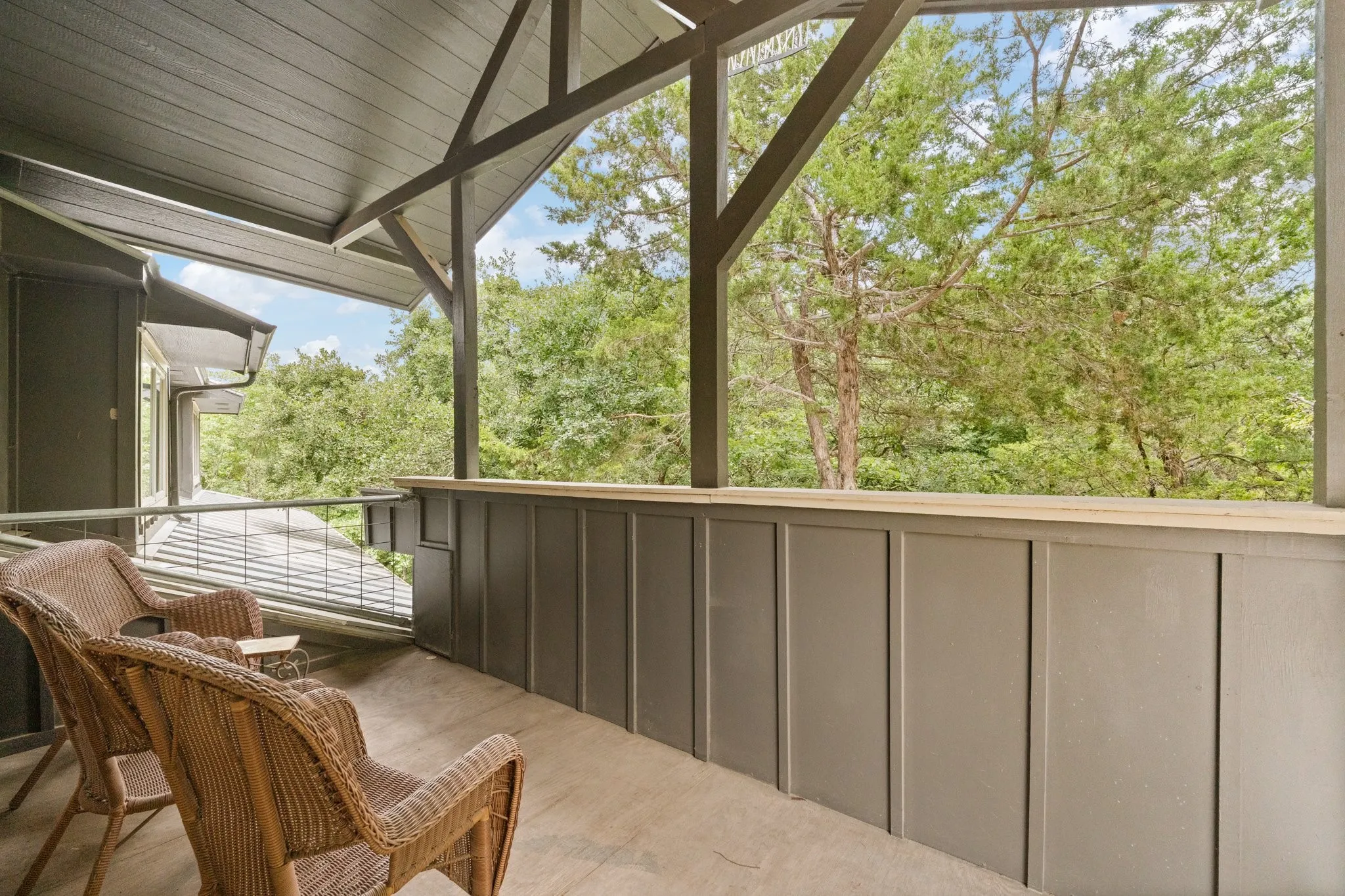 Covered balcony off the upstairs living area,  overlooks the backyard and brings a feeling of sitting high in a treehouse, surrounding my lush landscape and 360 views of trees