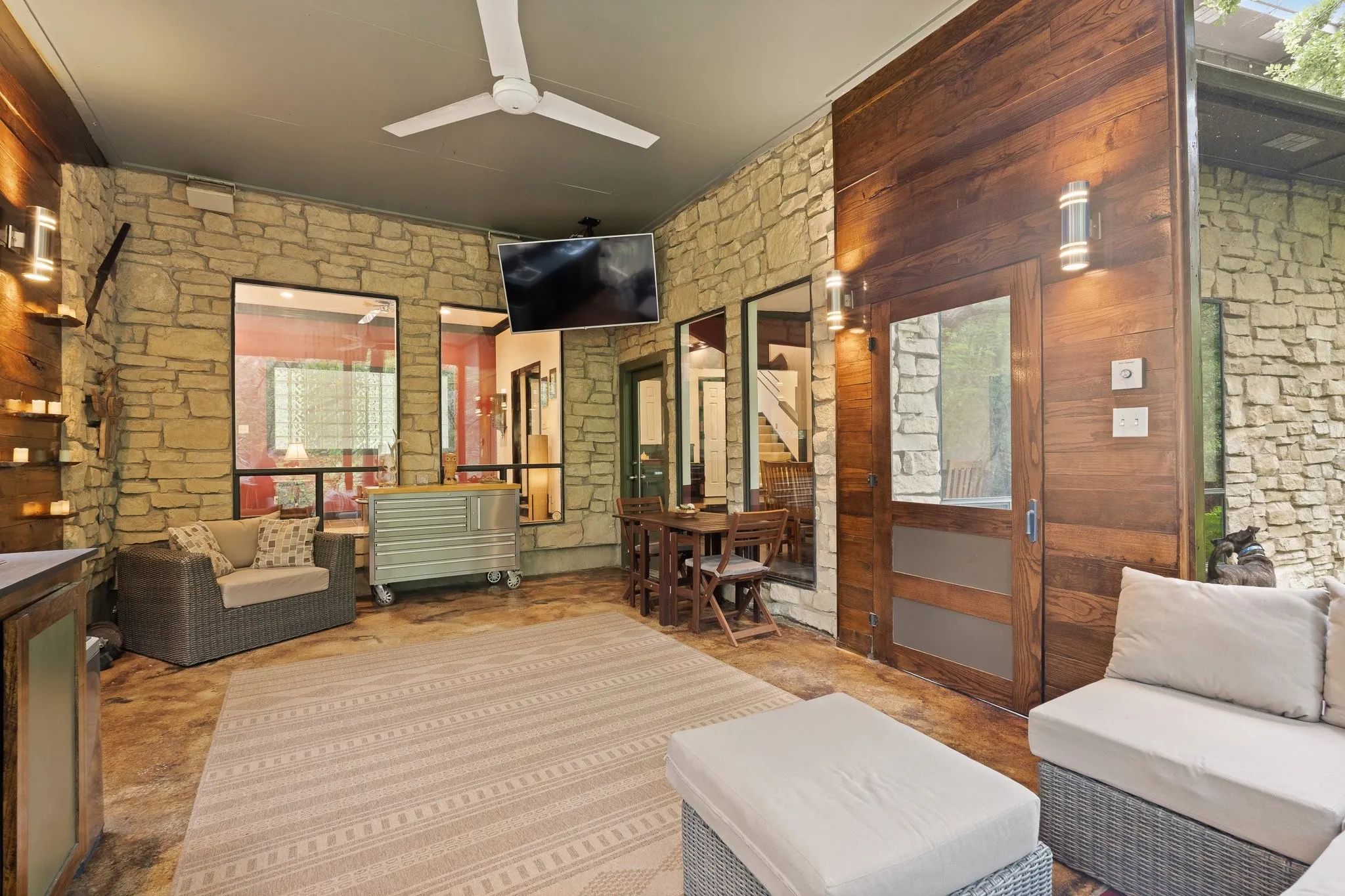 Screened in porch looking towards the inside of the home with stone accent wall