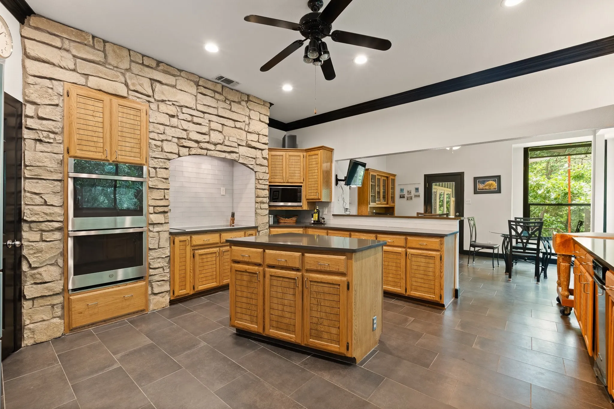 Another view of the kitchen showcasing the double oven and overlooking the breakfast area