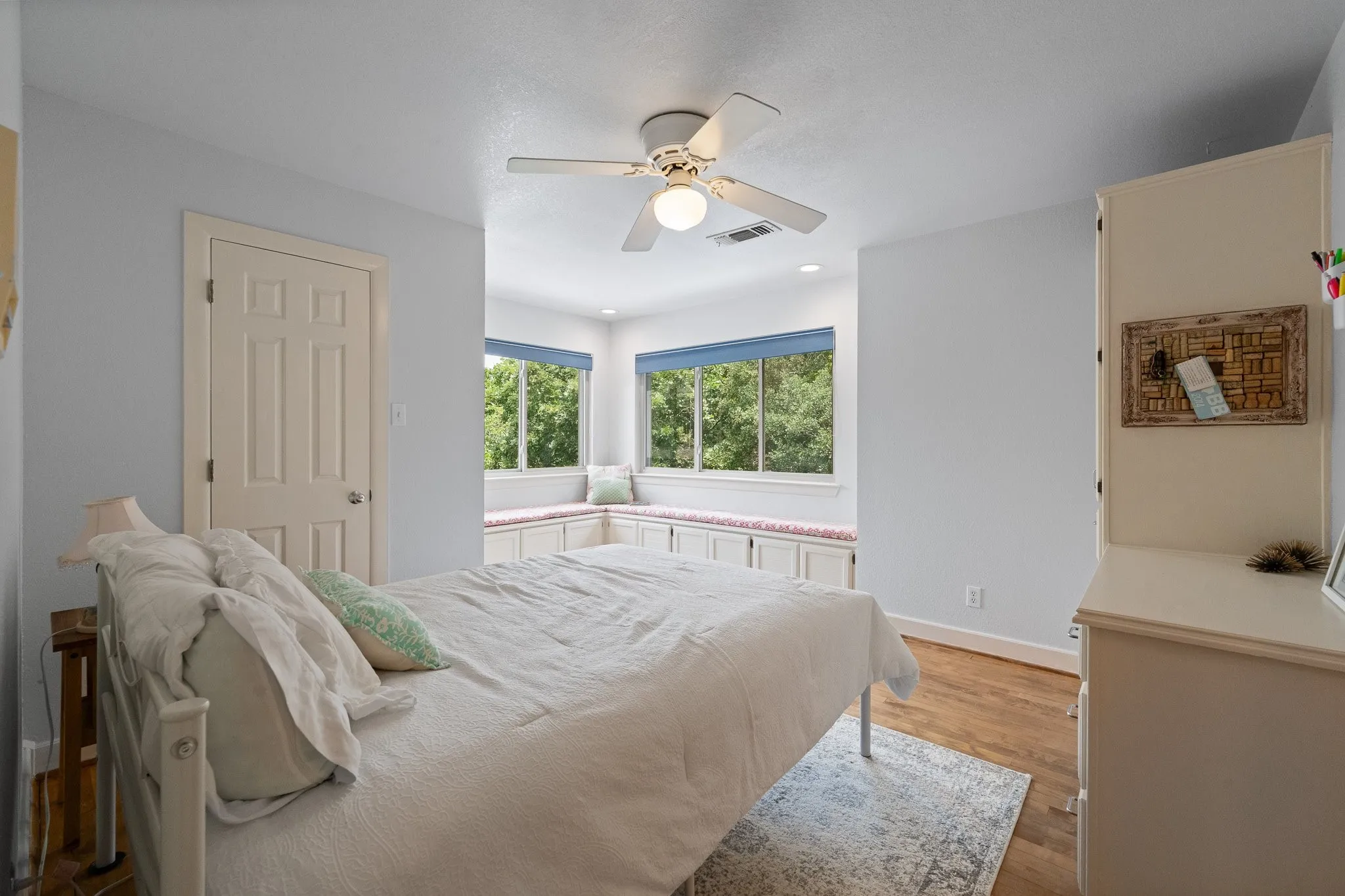 Bedroom with window seating and storage cabinetry below, overlooks the backyard and provides the ultimate privacy and beautiful views of nature right outside your windows bringing the outdoors inside