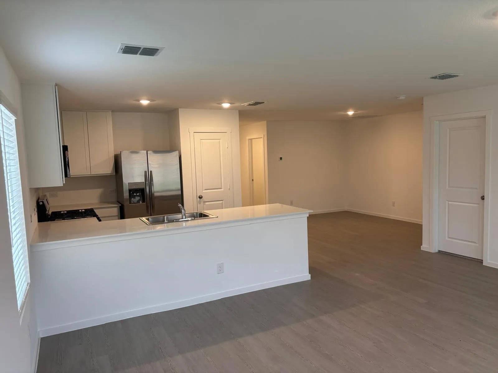 Open-concept living area featuring light wood-finish flooring