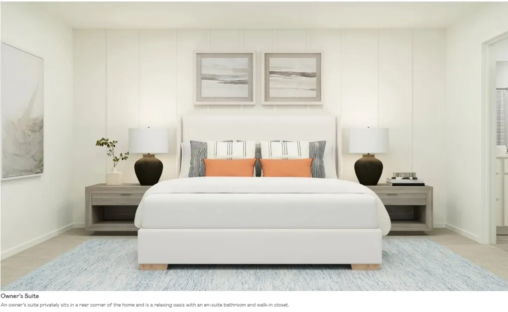 Bedroom featuring a paneled accent wall, light-toned carpeting, and a doorway leading to an adjoining bathroom