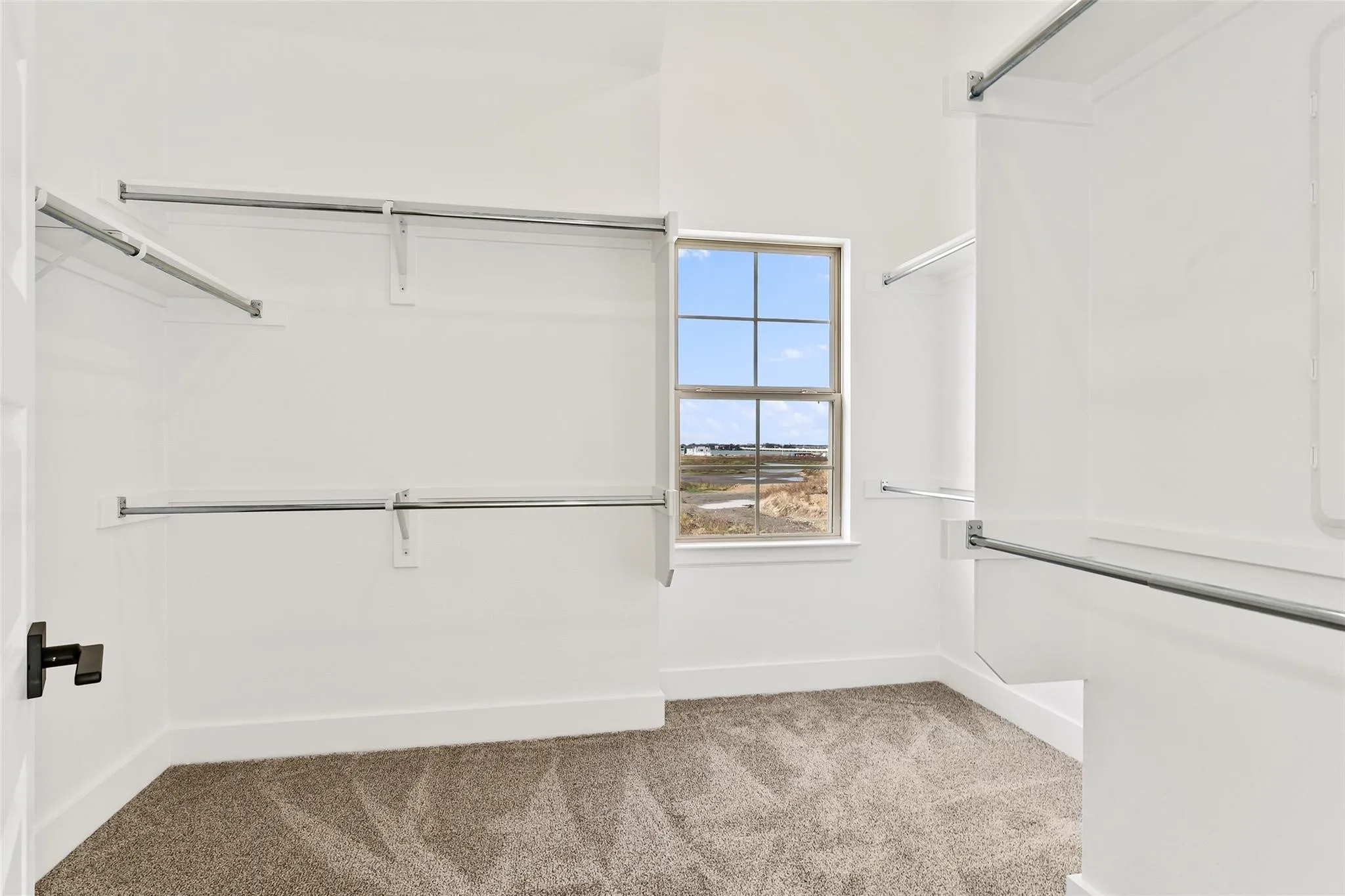Large walk in closet with window viewing lake