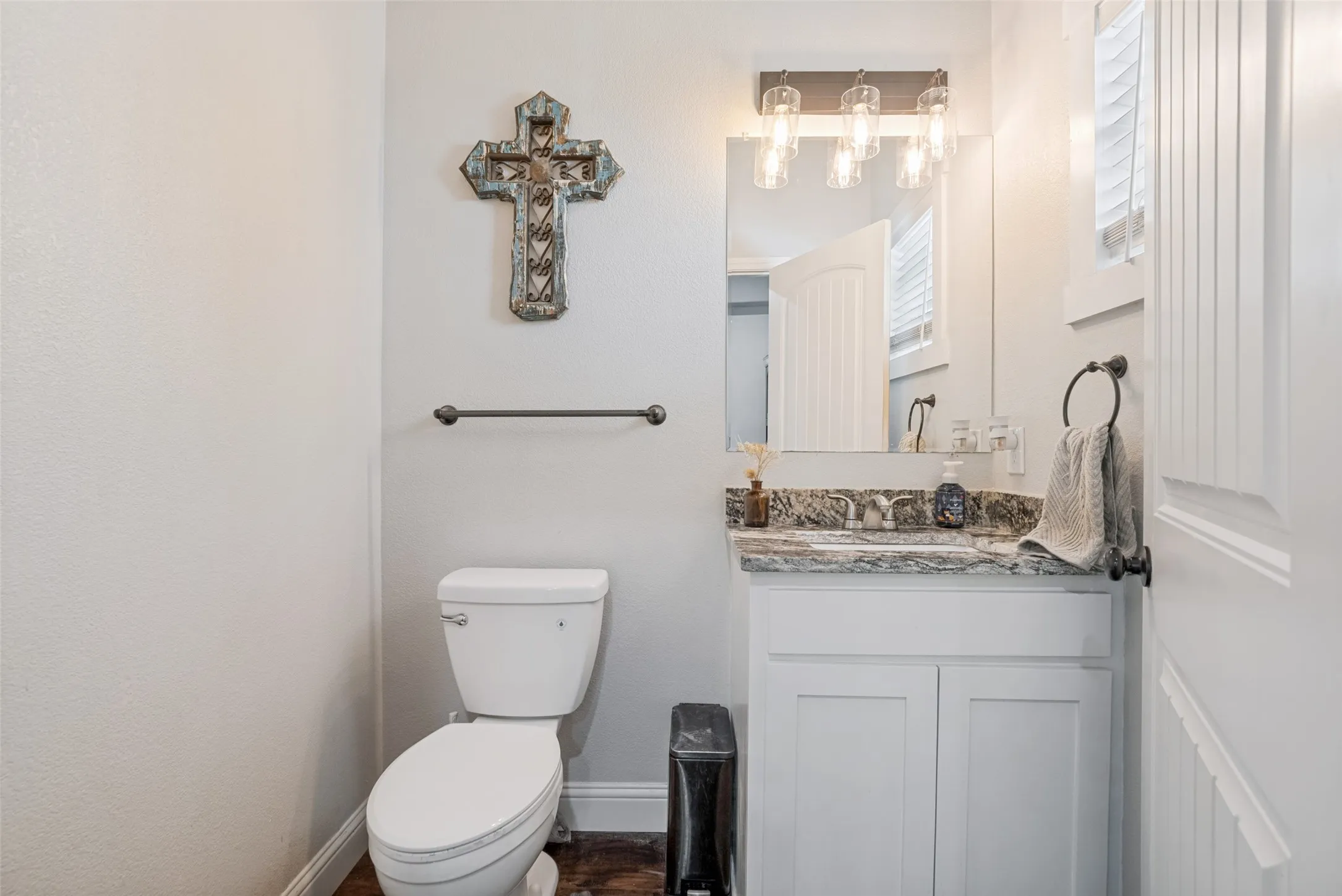 Vanity with a granite countertop and undermount sink