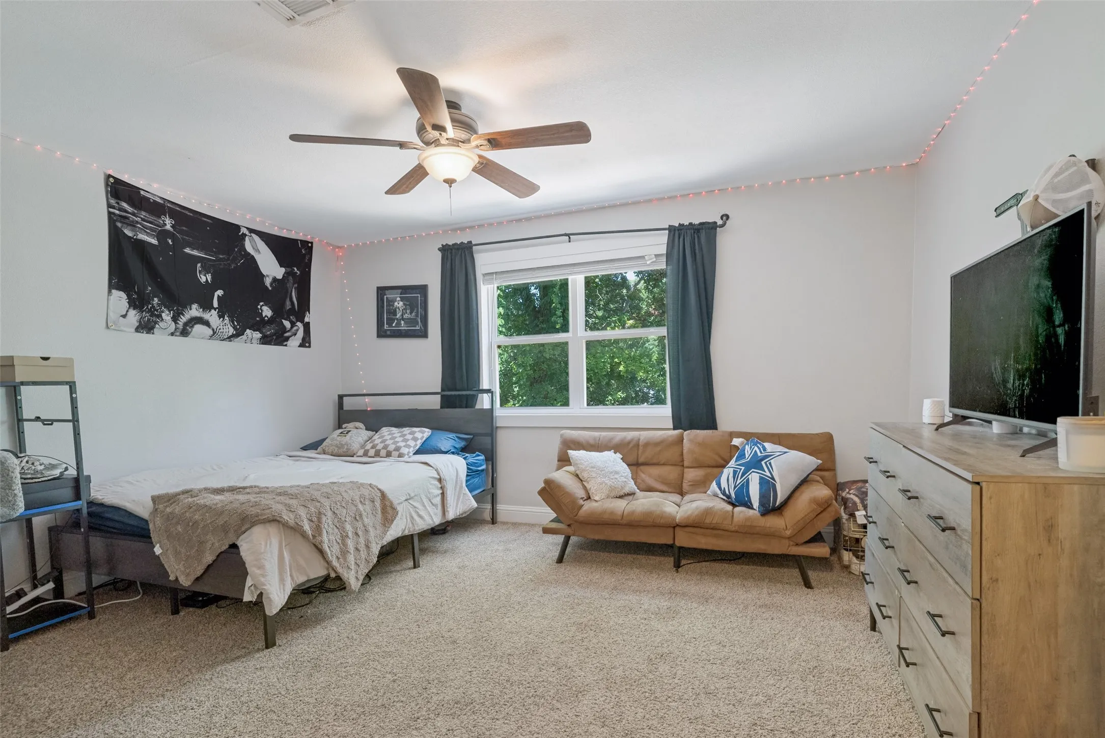 Room featuring carpet flooring and a ceiling fan with integrated lighting
