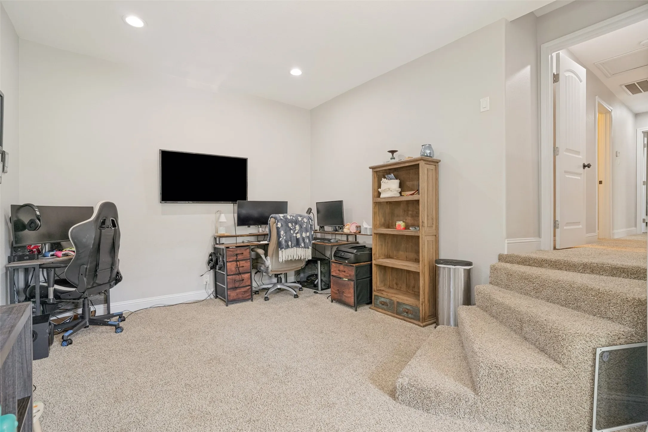 Carpeted lower level room featuring recessed lighting and light-toned wall paint