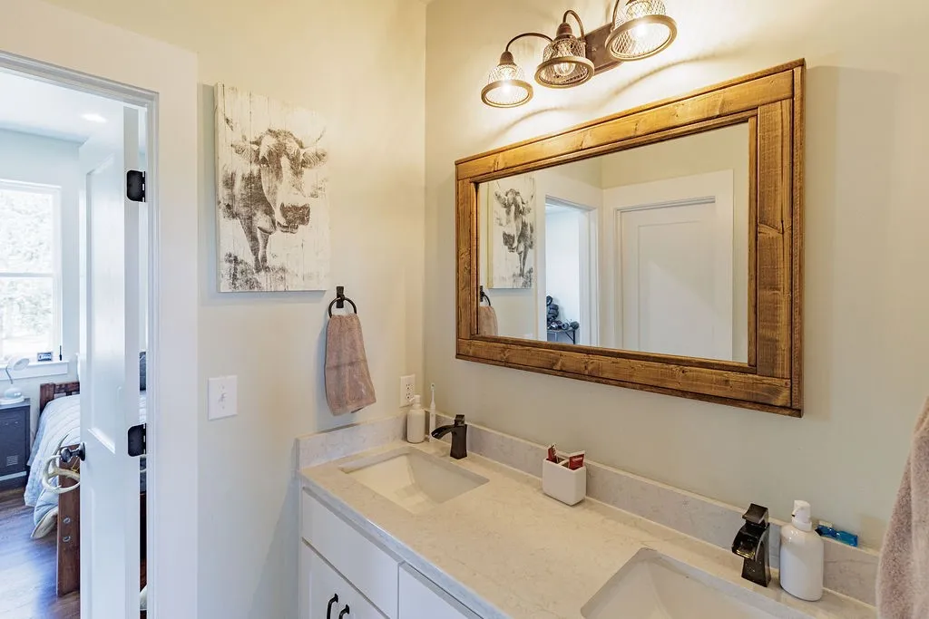 jack and jill bath on second floor with dual undermount sinks with shower and toilet separate