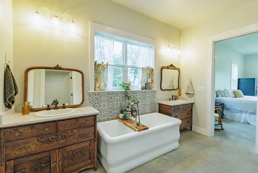 relaxing primary bathroom with separate vanities, 7 foot soaking tub and notched out make-up space beside shower