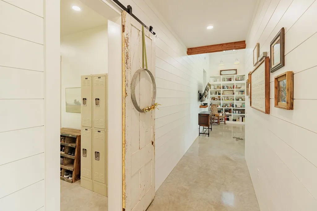 hallway with barn door to the laundry room