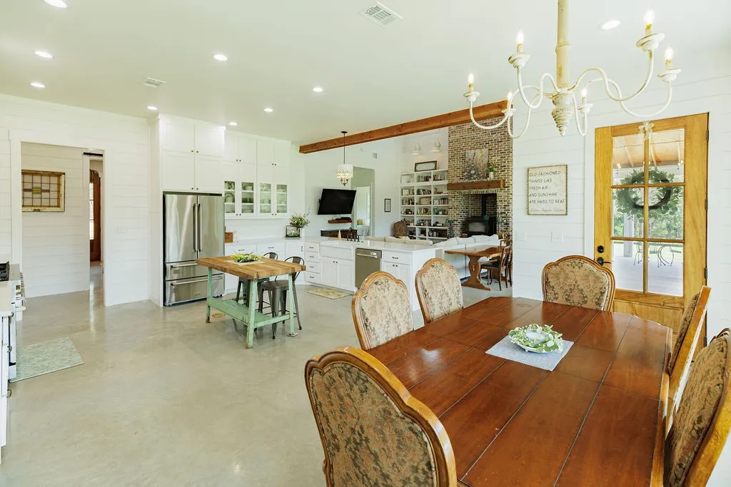 open-concept living space includes dining area, over-sized kitchen, and living room