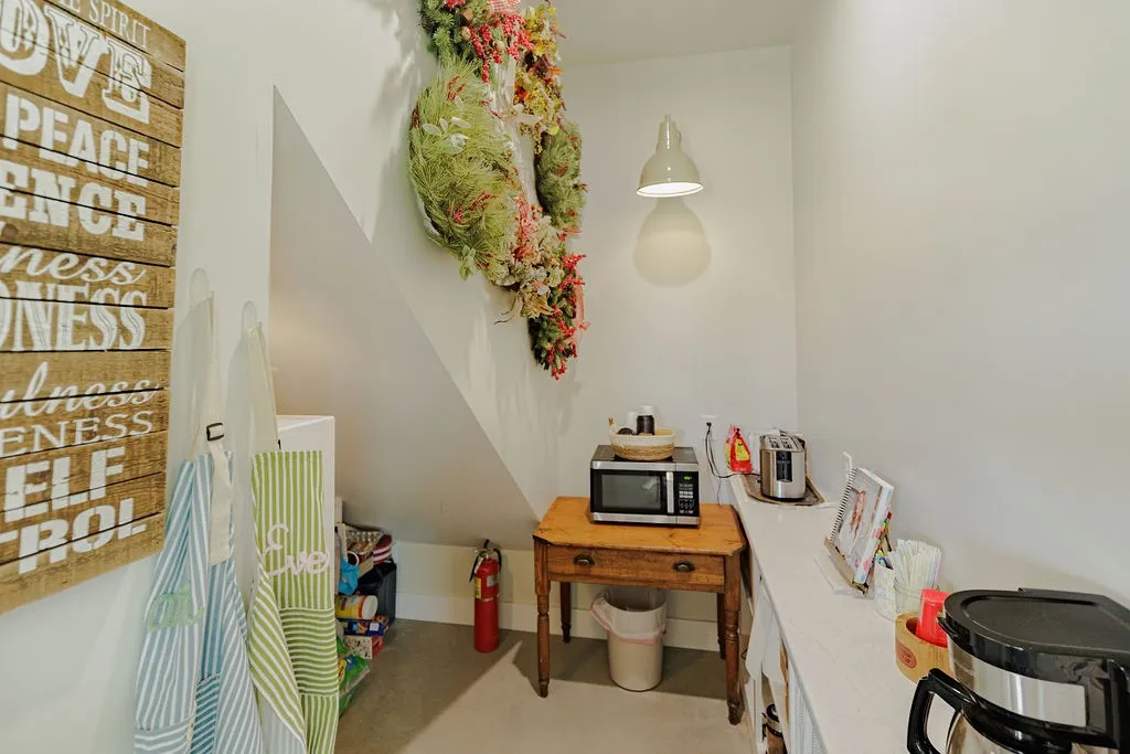walk-in pantry with built in shelves under stairs