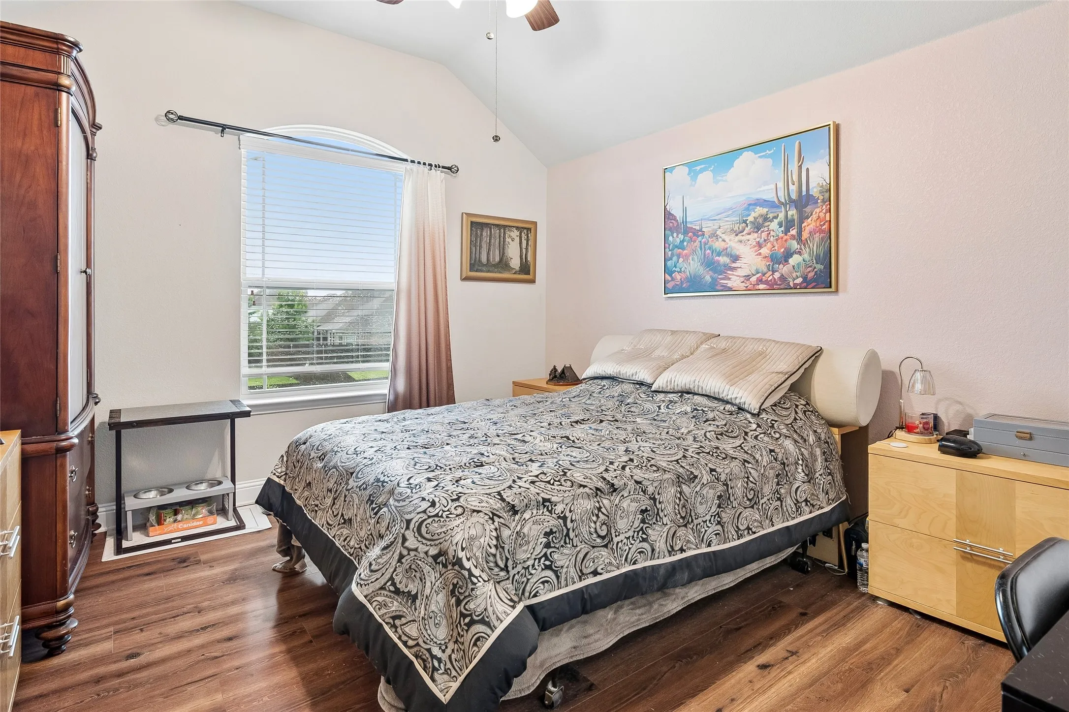 Fourth bedroom with large window and wood floors