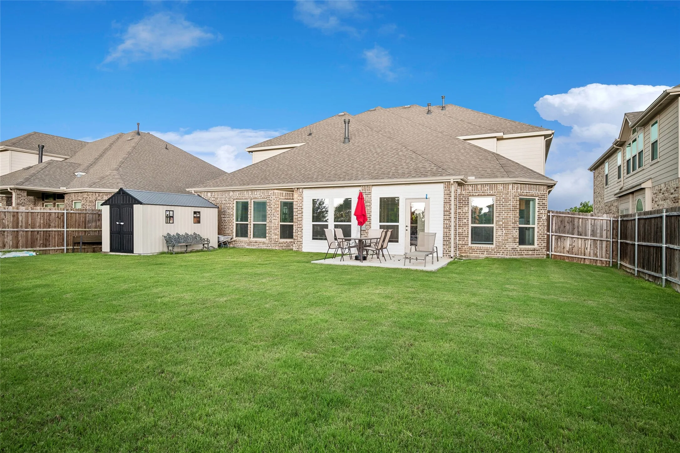 Large yard with recent patio and shed on foundation