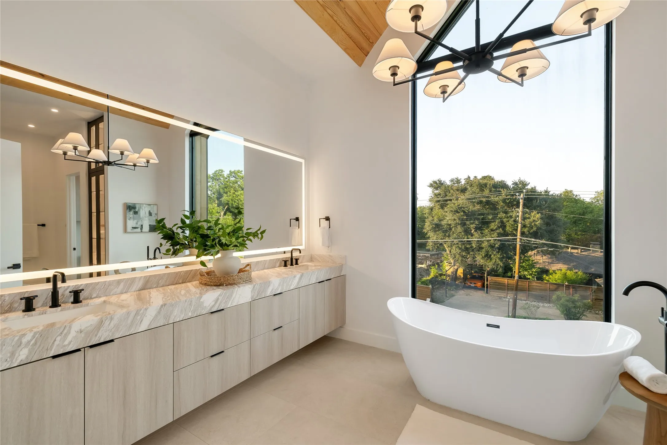 Freestanding soaking tub with a full-height window